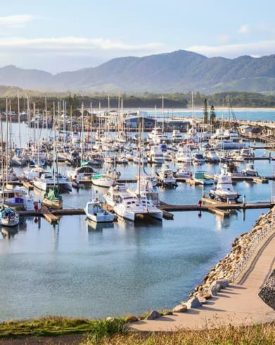 Coffs Harbour marina with boats moored against a mountain backdrop