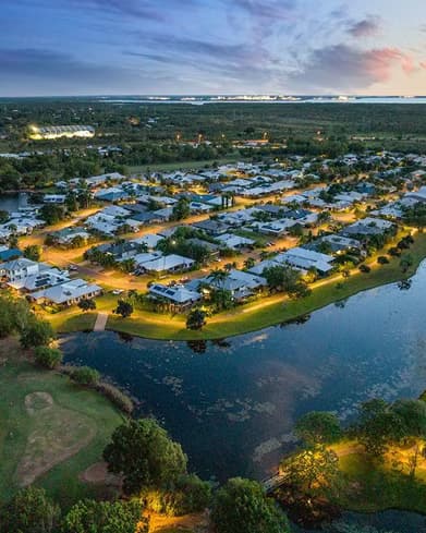 Aerial dusk view of a leafy Palmerston riverside suburb