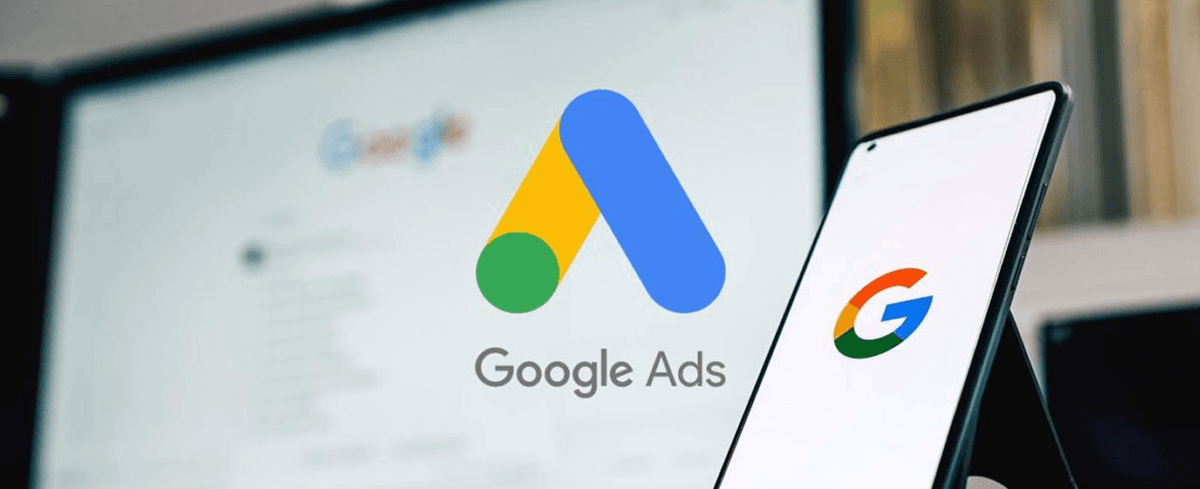 Google Ads logo on a smartphone with a Google search results page in the background