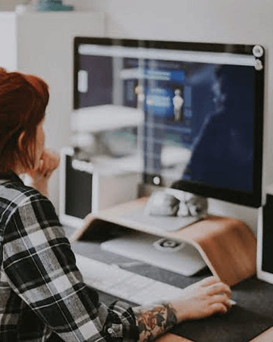 Designer reviewing a website design on a desktop monitor