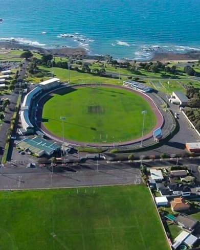 Aerial view of a sports oval beside the Devonport coastline