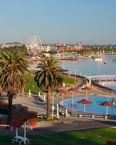 Geelong's waterfront promenade with a Ferris wheel and palm trees