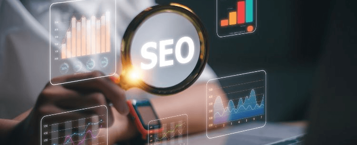 Magnifying glass over the word SEO with colourful performance charts in the background